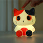 Oranje siliconen nachtlampje voor kinderen met schattig kat-ontwerp, zachte LED-verlichting, geschikt als sfeervol kinderkamer decor.